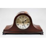 An early 20th century mahogany cased mantel clock, the silvered dial showing Roman numerals,having