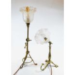 An Edwardian adjustable brass table lamp, the frilled glass shade above a tripod base; together with