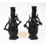 A pair of oriental bronze vases, naturalistically formed and signed verso, height 28cm