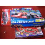 A Scalextric Silverstone set in box; together with a SCX McLaren F1 racing system; and two others by