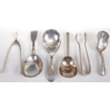 Assorted silver caddy spoons, to include a Victorian shovel example with engraved handle, a