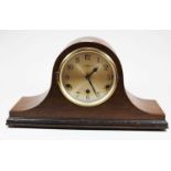 An early 20th century oak cased mantel clock, the silvered dial showing Arabic numerals and signed