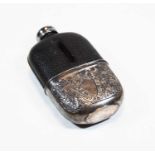 A late Victorian pocket hip flask, having a leather clad glass body, with removable silver plated
