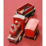 A child's model train, painted in red and green, with accompanying carriages, h.30cm