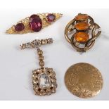 A gilt metal and amethyst set brooch; together with a pinchbeck and orange stone set brooch; a paste