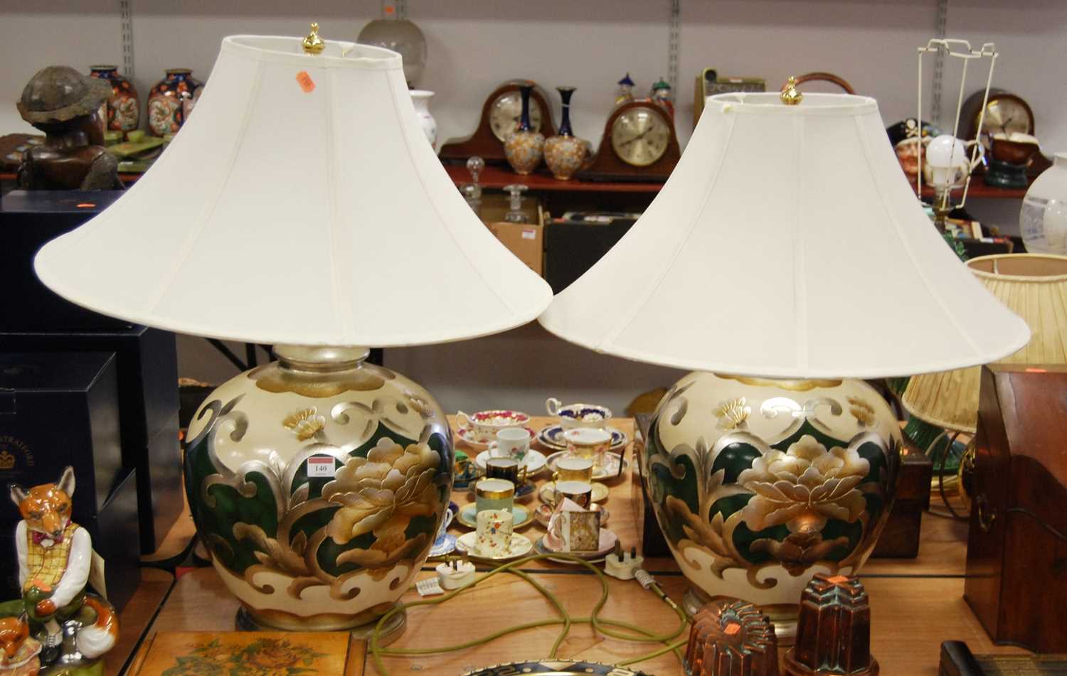 A pair of large contemporary table lamps, each of bulbous form, decorated in shades of cream, green,