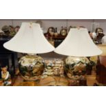 A pair of large contemporary table lamps, each of bulbous form, decorated in shades of cream, green,