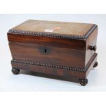 A Regency mahogany box, of sarcophagus form, with kite escutcheon and carved decoration, standing on
