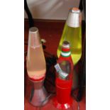 Three various lava lamps, to include one as a tomato ketchup bottle