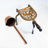 A 19th century pierced brass trivet, having turned mahogany handle, on wrought iron supports;