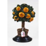 A 20th century painted cast iron door-stop, in the form of an orange tree, h.29cm