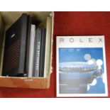 A box of assorted watch related volumes and catalogues, to include Rolex, Patek Philippe, and Tudor