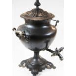 A Victorian pewter samovar, of urn form, flanked by twin handles and standing on a shaped base, h.