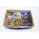 A box of miscellaneous costume jewellery to include silver locket with floral engraved decoration,