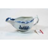 An 18th century Lowestoft porcelain sauceboat, blue & white decorated with a Chinese landscape 11.