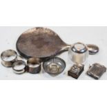 Assorted silver wares, to include napkin rings, vesta, matchbox sleeve, and a silver topped glass