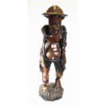 A 20th century carved hardwood figure of a gentleman, in standing pose, on a circular base, h.66cm