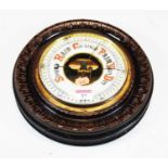 An early 20th century stained pine aneroid wall barometer, with circular enamel dial and carved