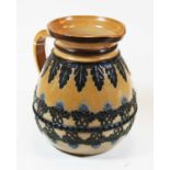 A Doulton Lambeth stoneware jug having impressed circle mark, numbered 1884, artist initials LG,