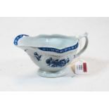 An 18th century Worcester porcelain relief moulded blue & white decorated sauce boat, crescent C