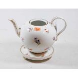 An early 20th century continental porcelain bullet shaped teapot having floral decoration heightened