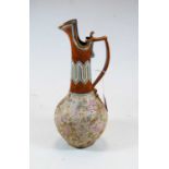 A Royal Doulton stoneware ewer, with beaded and floral decoration, h.31cm