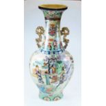 A large 20th century Japanese satsuma style vase, of shaped form, flanked by twin gilt handles,