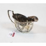 A late Victorian silver and embossed cream jug, 1.9oz, Chester assays, w.12.5cm