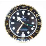 A contemporary wall clock, the dial in the form of a Rolex Perpetual Date GMT Master II watch