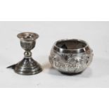 A Middle Eastern white metal dwarf candlestick; together with an Indian white metal and embossed