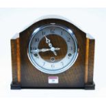A 1930s oak cased mantel clock, the chapter ring showing Arabic numerals, 8-day movement with