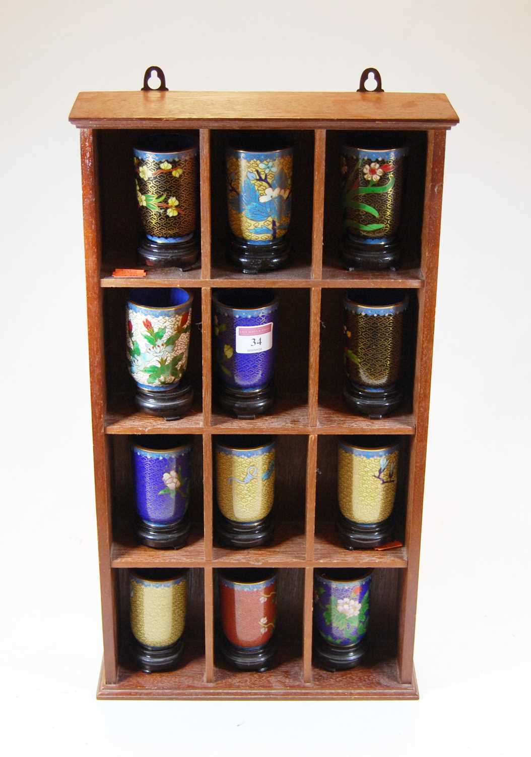 A set of twelve Chinese cloisonné enamel spill vases on stands, each decorated with flowers,