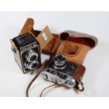 A leather cased Halina medium format camera; together with a 35mm SLR camera (2)