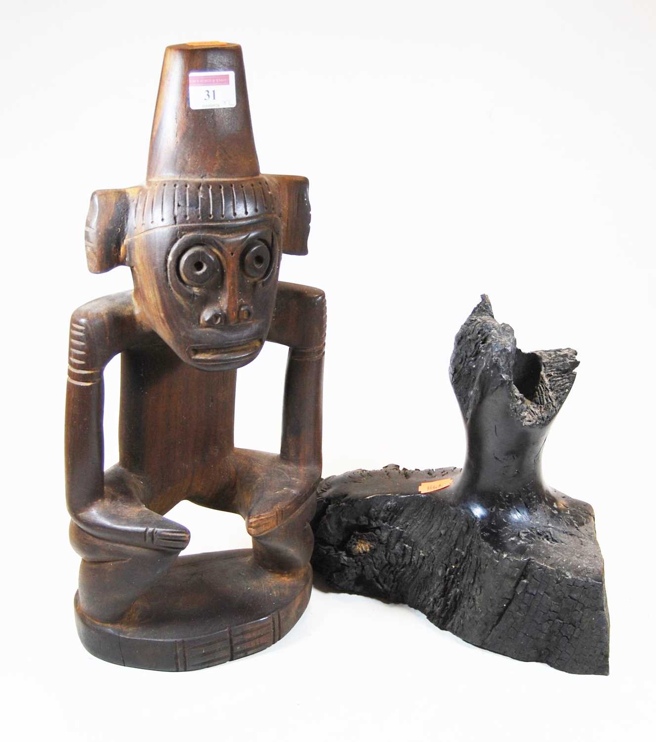 A 20th century carved hardwood figure of a stylised monkey, h.42cm, together with a hardwood