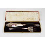 A cased pair of late Victorian silver plated and horn handled fish servers, each with silver and