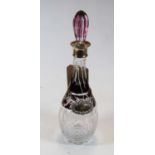 A ruby flash overlaid decanter and stopper having silver collar, height 38cm, together with a silver