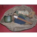 A canvas bag and contents mainly being militaria to include WWI style trench club with weighted