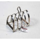 A George V silver four-division toast rack, having shield shaped loop handle, maker Viner's,