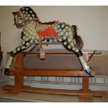 A Collinson mid-20th century child's dapple-grey rocking horse, with padded vinyl and studded