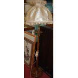 A turned walnut standard lamp with shade, h.147cm (excluding shade)