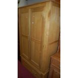 A contemporary light oak double door wardrobe, with single long lower drawer, w.111cm