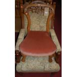 A Victorian mahogany and floral needlework upholstered armchair, raised on turned forelegs, w.