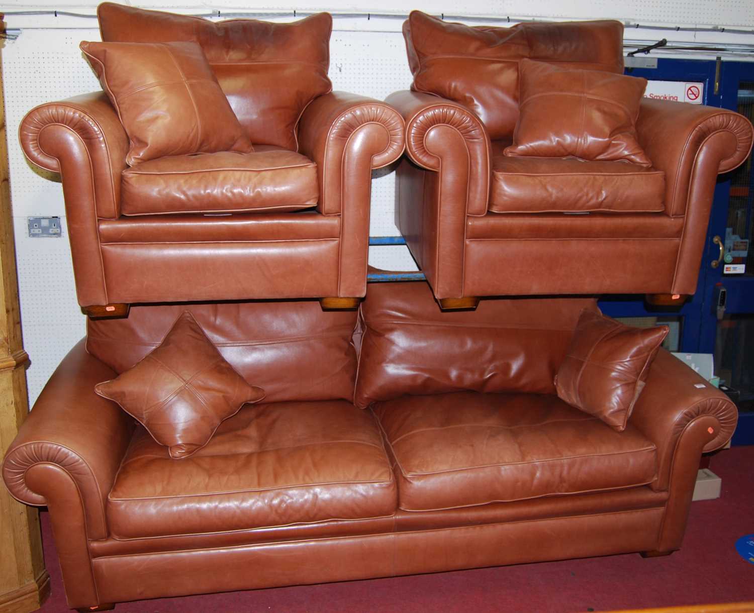 A contemporary Duresta tan leather three piece suite, comprising; three seater sofa and pair of