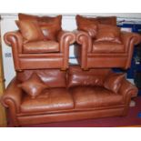 A contemporary Duresta tan leather three piece suite, comprising; three seater sofa and pair of