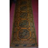 A Persian woollen rust ground hall runner, 300 x 76cm