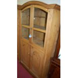 A reclaimed pine side cabinet, having arched twin glazed upper doors over further recessed