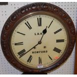 A Victorian rosewood(?) circular wall clock, the cream enamel dial with Roman numerals and signed