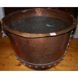 A large early 20th century copper circular log bucket, with flattened rim and of typical riveted