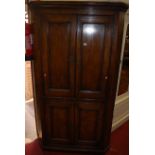 A joined oak four door freestanding corner cupboard, h.190cm