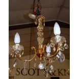 A gilt metal three branch hanging electrolier, with cut crystal glass drops, approx drop 50cm